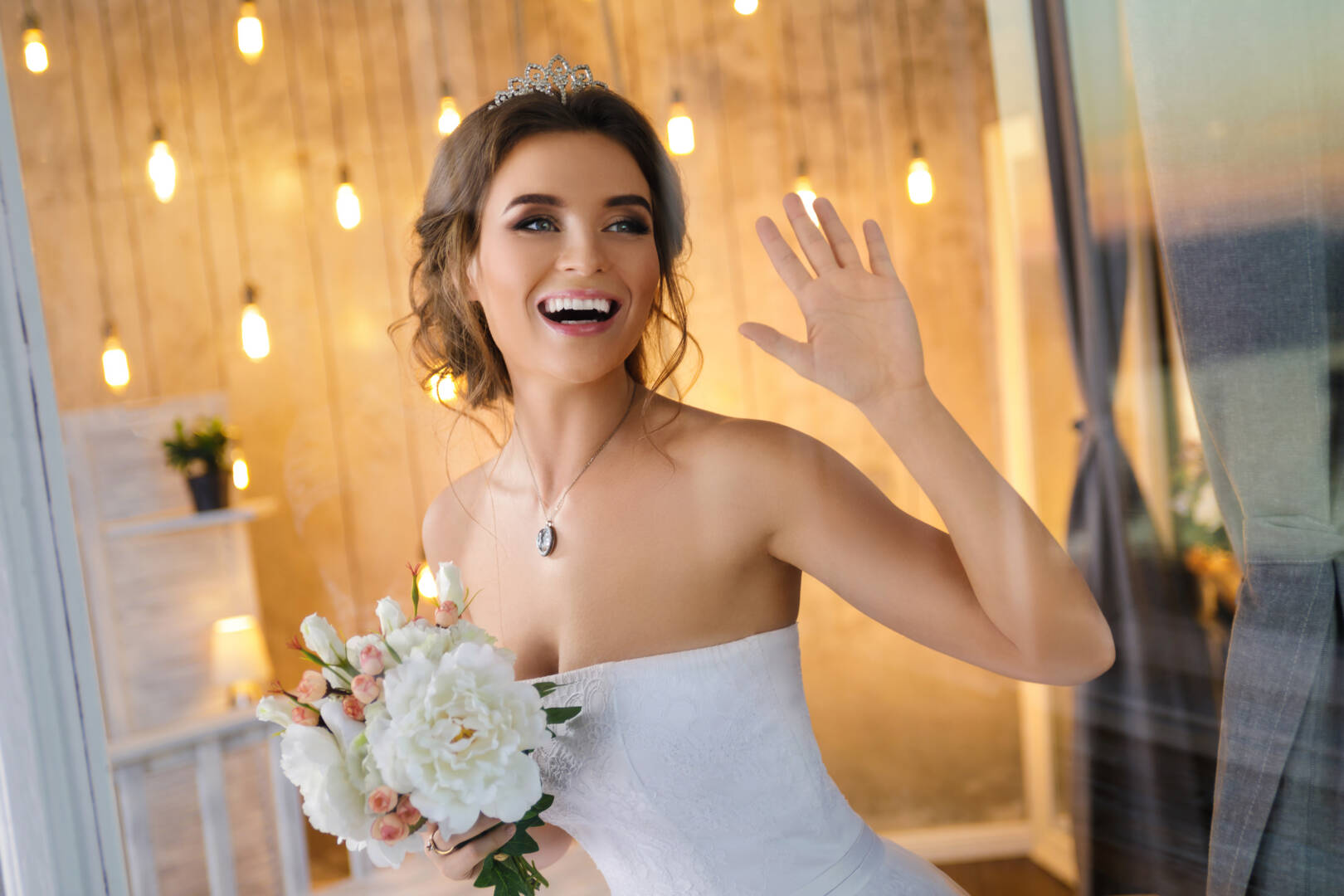 Happy and beautiful bride with bouquet of flowers